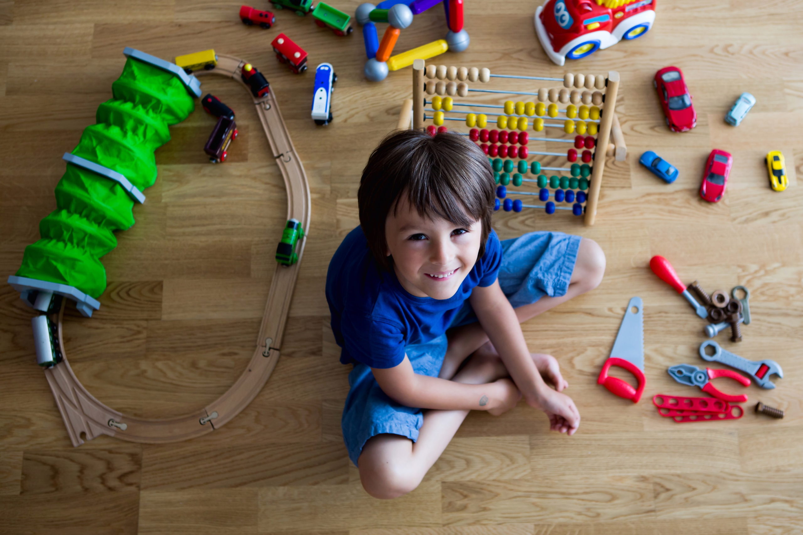 Young boy playing with toys in room